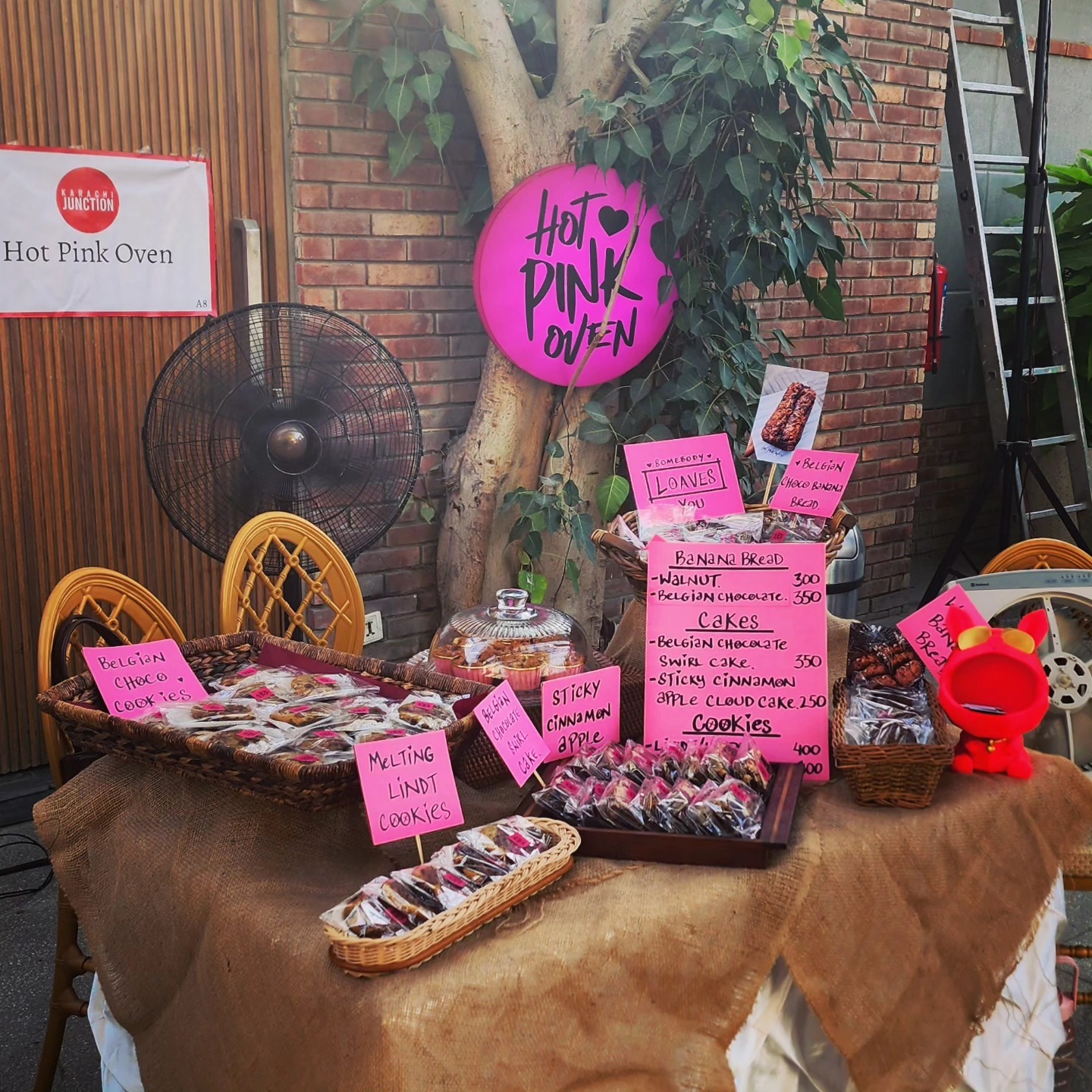 Hand-lettered pink cards over baskets of wrapped loaves